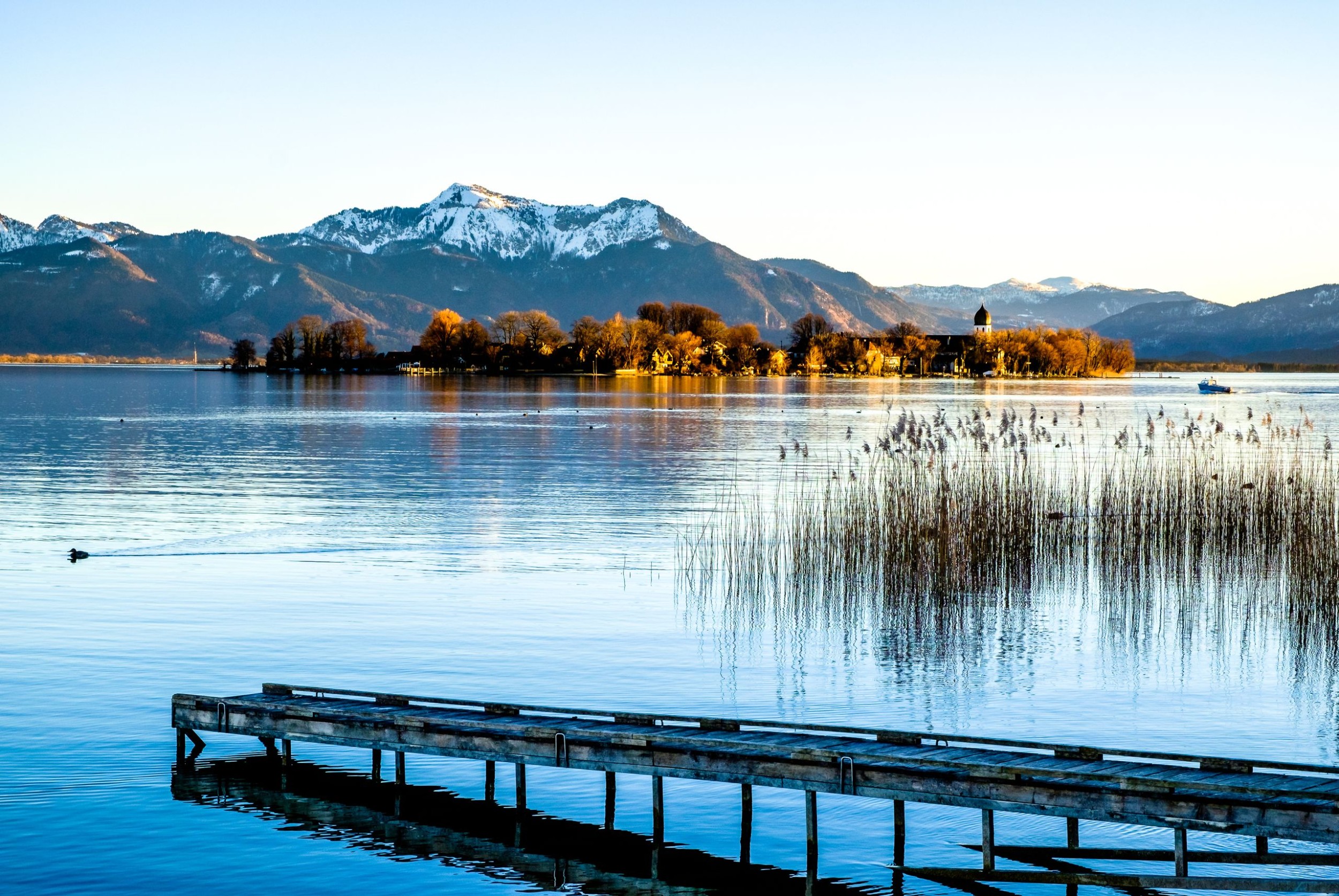 Steg am Chiemssee mit Bergen im Hintergrund